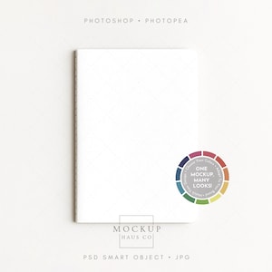 May include: A white notebook with a diamond pattern on the cover. The text "PHOTOSHOP • PHOTOPEA" is at the top, and "MOCKUP HAUS CO" is at the bottom. A colour wheel with the text "ONE MOCKUP, MANY LOOKS!" is on the right.