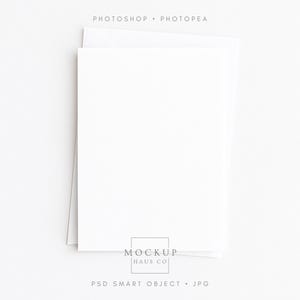 May include: A stack of white stationery, including a folded card and an envelope, against a white background. The text "PHOTOSHOP • PHOTOPAE" is at the top, and "MOCKUP HAUS CO" and "PSD SMART OBJECT • JPG" are at the bottom.