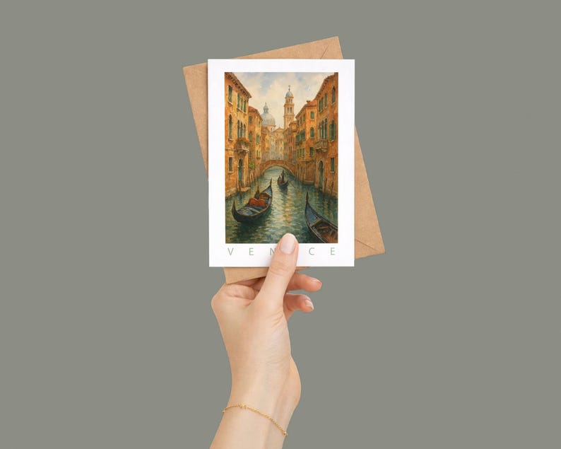 May include: A watercolor postcard featuring a Venetian canal scene with gondolas, buildings, and a bridge. The postcard is held with a brown envelope. The word "VENICE" is printed at the bottom of the postcard.