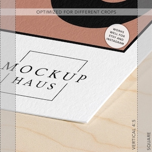 May include: A white paper mockup featuring the black text MOCKUP HAUS inside a thin black square outline. The paper has a textured surface and displays a partial black and peach graphic. A circular sticker reads WORKS WELL FOR ETSY AND INSTAGRAM.