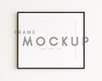 May include: A rectangular black frame with a white mat, displaying the text "FRAME MOCKUP" in a minimalist font. Below the text are the file types: JPG, PNG, and PSD. The frame is centered on a white background.