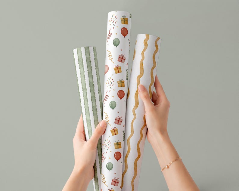 May include: Three rolls of decorative wrapping paper are held up against a light green background. The rolls feature various patterns, including green stripes, balloons, gifts, and wavy gold lines. The paper is designed for gift wrapping.