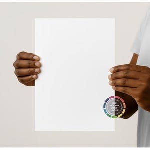 May include: A blank white sheet of paper held by a person. The paper is rectangular and takes up most of the image. A colour wheel with the text "ONE MOCKUP MANY LOOKS" is visible on the bottom right corner.