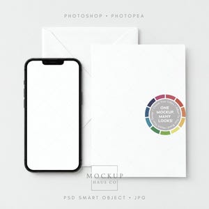 May include: A black smartphone with a blank white screen positioned next to a white envelope. A circular colour wheel graphic on the envelope contains the text ONE MOCKUP, MANY LOOKS! along with the brand name MOCKUP HAUS CO at the bottom.