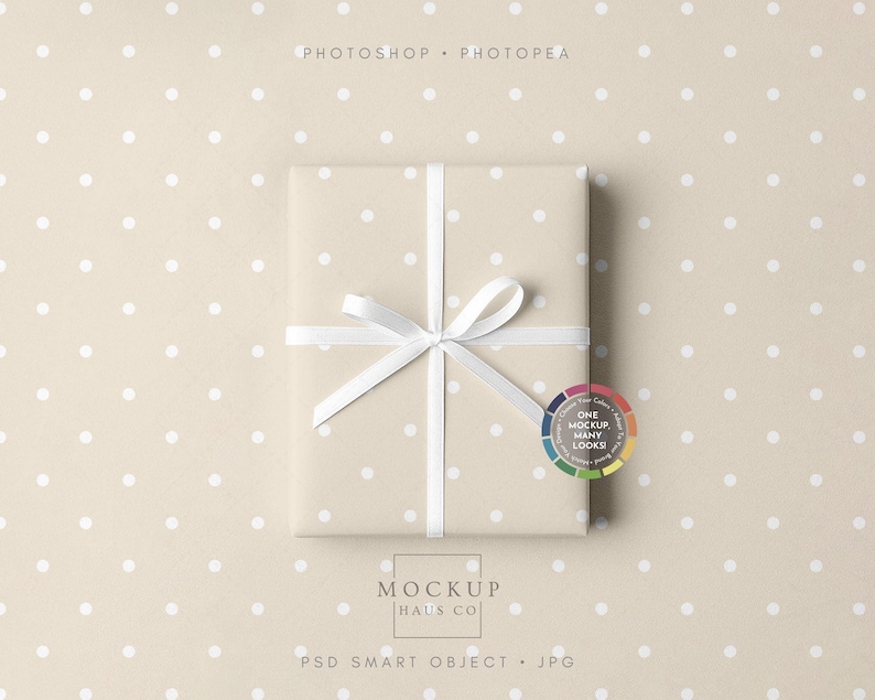 May include: A wrapped gift box with a white ribbon and bow, presented on a beige polka dot background. The box is wrapped in beige paper with white polka dots. The image includes the text "Photoshop + Photopea" and "Mockup Haus Co."