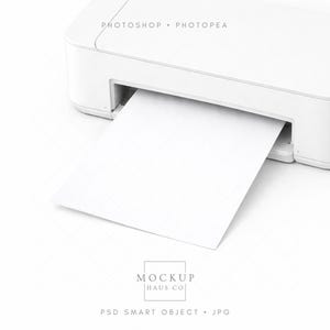 May include: A white printer with a sheet of white paper emerging from the output tray. The image includes the text "PHOTOSHOP • PHOTOPEA" at the top and "MOCKUP HAUS CO" and "PSD SMART OBJECT • JPG" at the bottom.