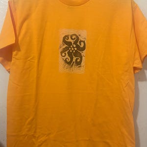 cosmic flower 2 black and yellow/orange tshirt