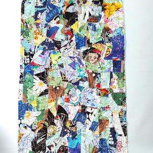 May include: A rectangular patchwork textile composed of various fabric scraps in a vibrant array of colors. The design features a collage of printed patterns, including floral, text, and abstract shapes, stitched together with visible thread.