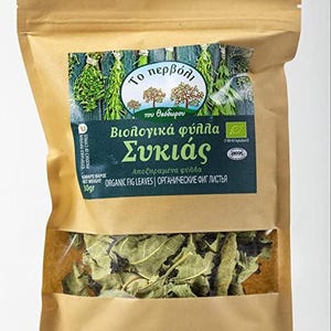 May include: A tan paper pouch containing 30g of dried fig leaves. The label features the text To pervoli tou Theodorou, Biologika fylla Sykias, and Organic Fig Leaves. A clear window at the bottom reveals the green, dried leaves inside the bag.