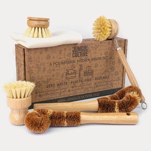 May include: A collection of six natural kitchen brushes, including a bamboo palm scrubbing brush, coconut fibre pan brush, and hemp & cotton dish cloths. The box reads "6 PCS NATURAL KITCHEN BRUSH SET" and "ZERO WASTE PLASTIC FREE REUSABLE".