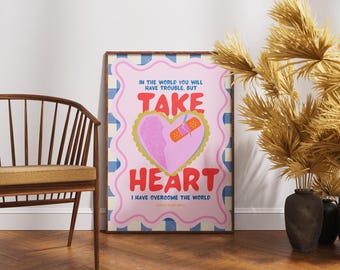 May include: A framed art print with a pink and blue design. The artwork features a pink heart with a bandage, and the words "TAKE HEART" in red. The text "I HAVE OVERCOME THE WORLD" is also included.