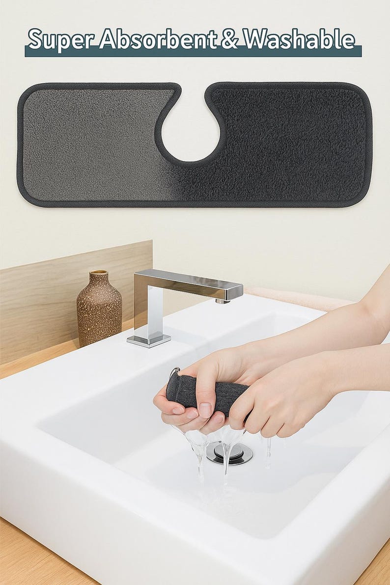 May include: A dark gray and light gray absorbent and washable sink mat with a U-shaped cutout. The text "Super Absorbent & Washable" is at the top. A person is wringing out a dark gray absorbent pad over a white sink.