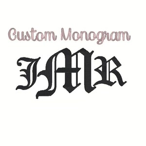 May include: A custom monogram design in a gothic font, featuring the letters JMR in black. The words "Custom Monogram" are above the letters in a cursive, light pink font, set against a white background.