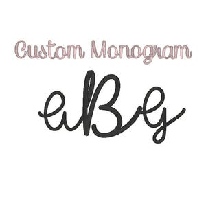 May include: A white background with the text "Custom Monogram" in a light pink script font. Below, the letters "aBg" are displayed in a black, cursive style. The overall design is simple and elegant.
