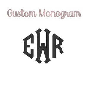 May include: A custom monogram design featuring the letters EWR in a bold, black, gothic font, enclosed within a hexagonal frame. The words "Custom Monogram" are written above in a cursive, light pink font, set against a white background.