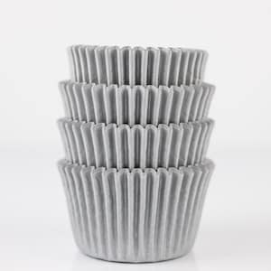 May include: A stack of four silver cupcake liners. The liners are made of paper and have a fluted design.