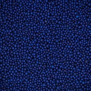 May include: A close-up image of a blue surface covered in small, round, blue beads.