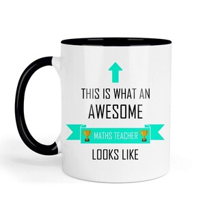 May include: White ceramic mug with a black handle and interior. The mug features the text "THIS IS WHAT AN AWESOME MATHS TEACHER LOOKS LIKE" in black font, with a teal arrow and banner design.