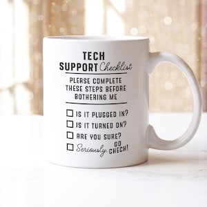 May include: White ceramic mug with the text "TECH SUPPORT Checklist" and a list of troubleshooting steps. The mug has a curved handle and is designed for coffee or tea. A humorous gift for tech support professionals.
