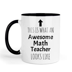 May include: White ceramic mug with a black handle and interior. The mug features the text "THIS IS WHAT AN Awesome Math Teacher LOOKS LIKE" in black, with an upward-pointing arrow above the text.