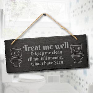May include: A black slate sign with the text "Treat me well & keep me clean I'll not tell anyone... what I have Seen" in white. The sign has a rope hanger and cartoon toilet illustrations.