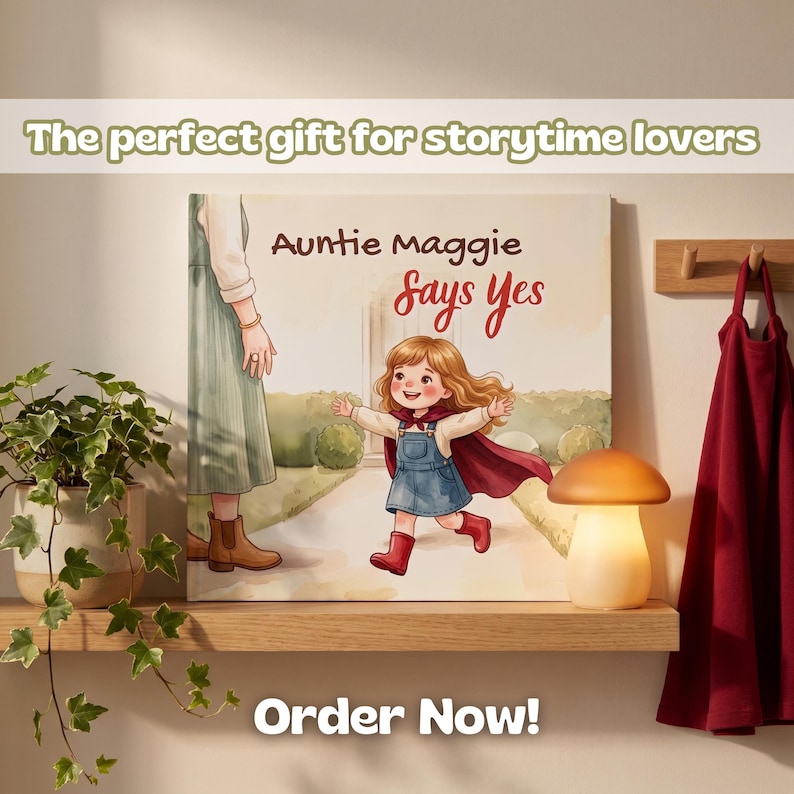 May include: A square wall art print featuring an illustration of a child with long brown hair wearing a blue denim dress, a red cape, and red boots running toward an adult. The text reads Auntie Maggie Says Yes. The print is on a wooden shelf.