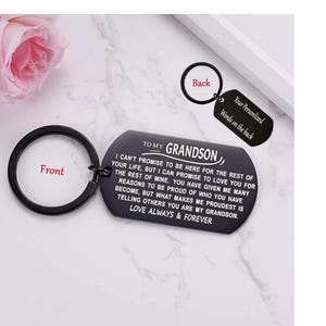 May include: A black metal keychain with a ring and a rectangular tag. The tag reads "TO MY GRANDSON" and includes a personalized message. The back of the tag says "Your Personalized Words on the back."