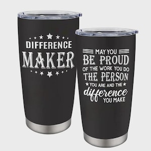 May include: Two black insulated tumblers with silver bottoms and clear lids. One tumbler reads "DIFFERENCE MAKER" in white text with star accents. The other reads "MAY YOU BE PROUD...THE DIFFERENCE YOU MAKE."