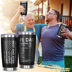 May include: Black stainless steel tumblers with silver rims. One tumbler features an American flag design with the words "BEST DAD EVER, DADDY, HUSBAND, PROTECTOR, HERO." Another has "#1 DAD" and a nutrition facts label. The third tumbler has "BEST DAD EVER."