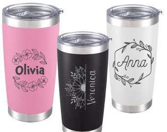 May include: Three stainless steel insulated tumblers with lids. One is pink with "Olivia" and floral design, one is black with "Veronica" and a floral design, and one is white with "Anna" and a floral design.