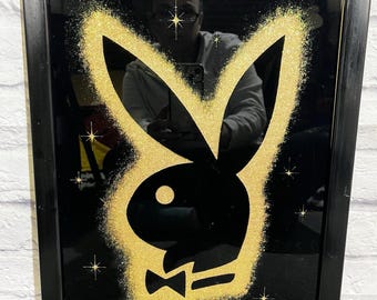 Lámina enmarcada vintage de Playboy Enterprises de 1986 con el logotipo del conejito en purpurina dorada y color negro.