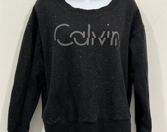 Sudadera Calvin Klein con estampado moteado • Forro polar negro • Talla S de mujer