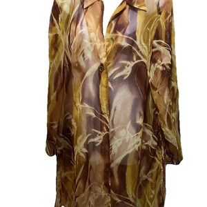 May include: A long-sleeved, button-down shirt in shades of brown, tan, and gold, with a flowing, semi-sheer fabric. The shirt features a botanical pattern and a classic collar.