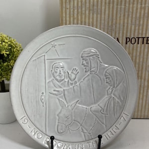 May include: A white ceramic mug with a black handle and the text "But First, Coffee" in a bold, black font. The mug is on a wooden surface. The mug is 10 cm tall.