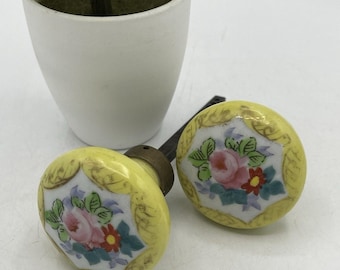 Juego de pomos de puerta de porcelana antigua con diseño floral amarillo y husillo de latón pintado a mano.