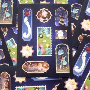 May include: A sticker sheet featuring multiple rectangular and ornate frame designs on a dark blue background. The illustrations include a white creature with a red apple, figures in blue cloaks, and characters in various settings with gold accents.