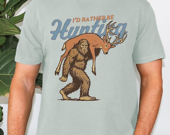 I'd Rather Be Hunting Shirt, Bigfoot Hunting Shirt, Funny Sasquatch Carrying Deer, Rustic Hunter Gift, Sasquatch Graphic Tee, Cryptid Tee