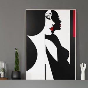 May include: A modern living room featuring a black and white art print of a woman with red lipstick. A green velvet chair and a black fireplace are in the foreground. Decorative plants and a white hand sculpture are on the mantle.