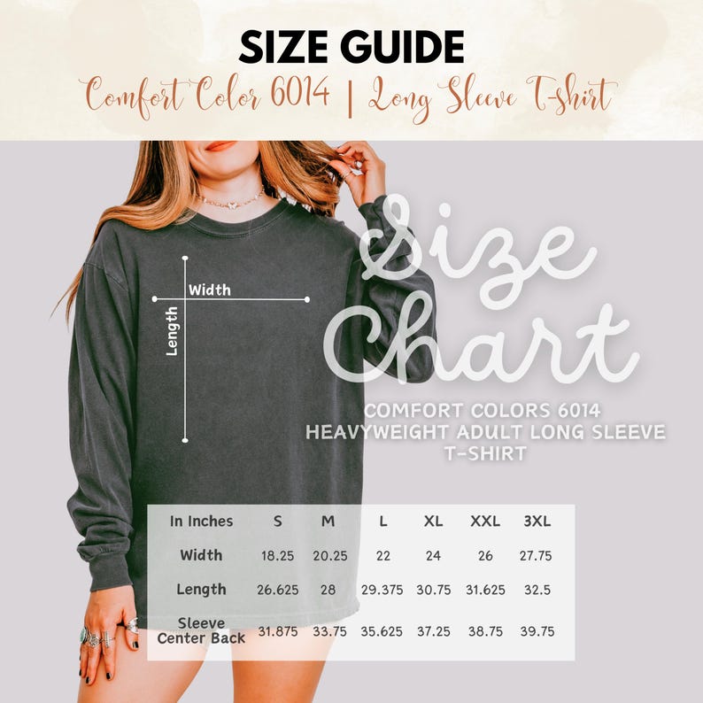 May include: Size guide for a Comfort Colors 6014 heavyweight adult long sleeve t-shirt. The chart shows measurements in inches for width, length, and sleeve center back for sizes S through 3XL. The shirt is a dark gray color.