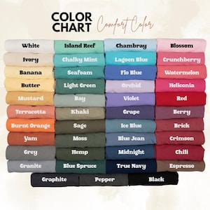 May include: A color chart displaying a variety of fabric colors, including white, blue, pink, and green. The text "COLOR CHART" and "Comfort Color" are at the top. Each color is labeled with its name, such as "White," "Chambray," and "Black."