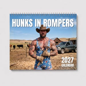 May include: A 2027 wall calendar titled HUNKS IN ROMPERS featuring a bearded individual wearing a brown cowboy hat and a blue floral print romper while holding a hammer. The background shows a rural farm setting with cattle and a pickup truck.
