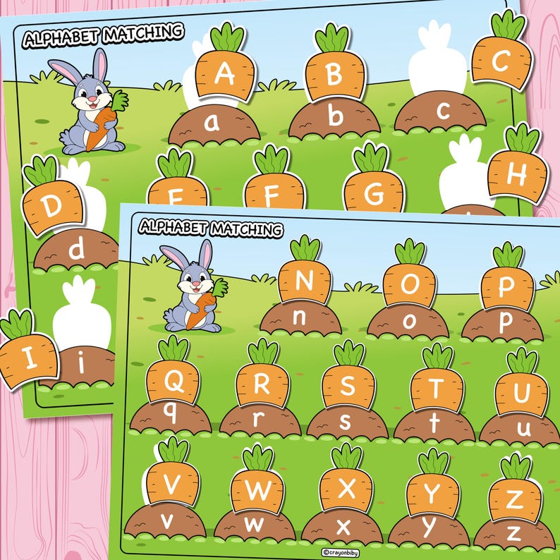 May include: Two alphabet matching game boards with a bunny holding a carrot. The boards feature carrots with uppercase and lowercase letters. The text "ALPHABET MATCHING" is at the top of each board. The background is green with a pink wooden surface.
