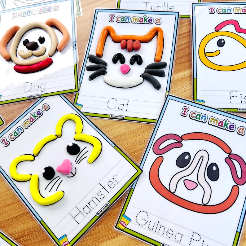 May include: Cards with colorful clay animal designs, including a dog, cat, hamster, and guinea pig. Each card has the words "I can make a" and the animal's name, with dotted lines for tracing. The designs are on white cards with a blue border.