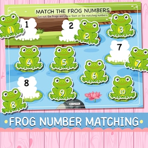 May include: A colorful educational game featuring green frog illustrations with numbers 1-10. The game is titled "Match the Frog Numbers" and includes cut-out frogs to match with corresponding numbers on lily pads. The background is a pond scene.