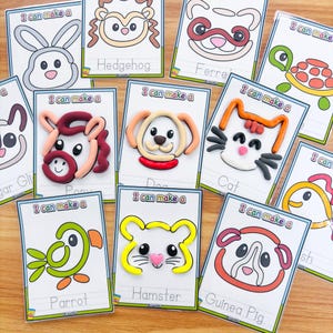 May include: A collection of colorful animal-themed craft cards. Each card features a line drawing of an animal, such as a dog, cat, or hamster, with the words "I can make a" above and the animal's name below.