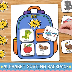 May include: An educational alphabet sorting activity featuring a blue backpack illustration with the letter Aa. The backpack displays square cards showing an alligator, an apple, and an ant. A hand places an airplane card onto the backpack.