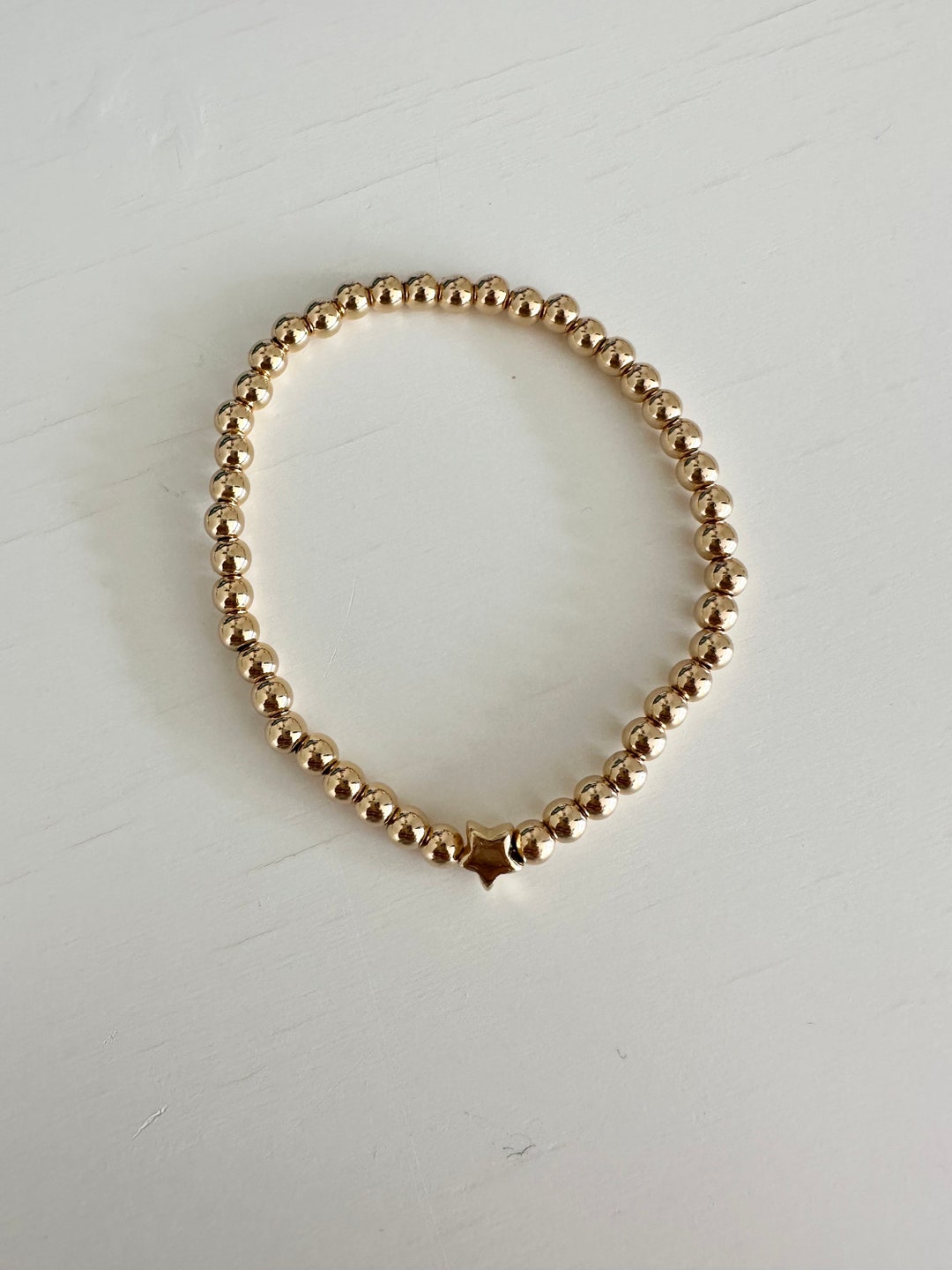 Gold Beaded bracelet with star charm main image 0