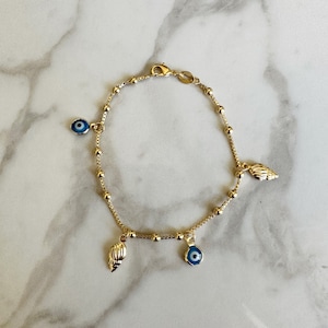 18k guldfyllt onda ögat armband med guldfärgade snäckskal - Eleganta strandsmycken