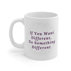 May include: White ceramic mug with a curved handle. The mug features the text "If You Want Different, Do Something Different" in a purple font, surrounded by a dotted design. The mug is designed for hot beverages.