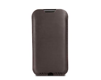 May include: A brown leather phone case with a stitched edge.